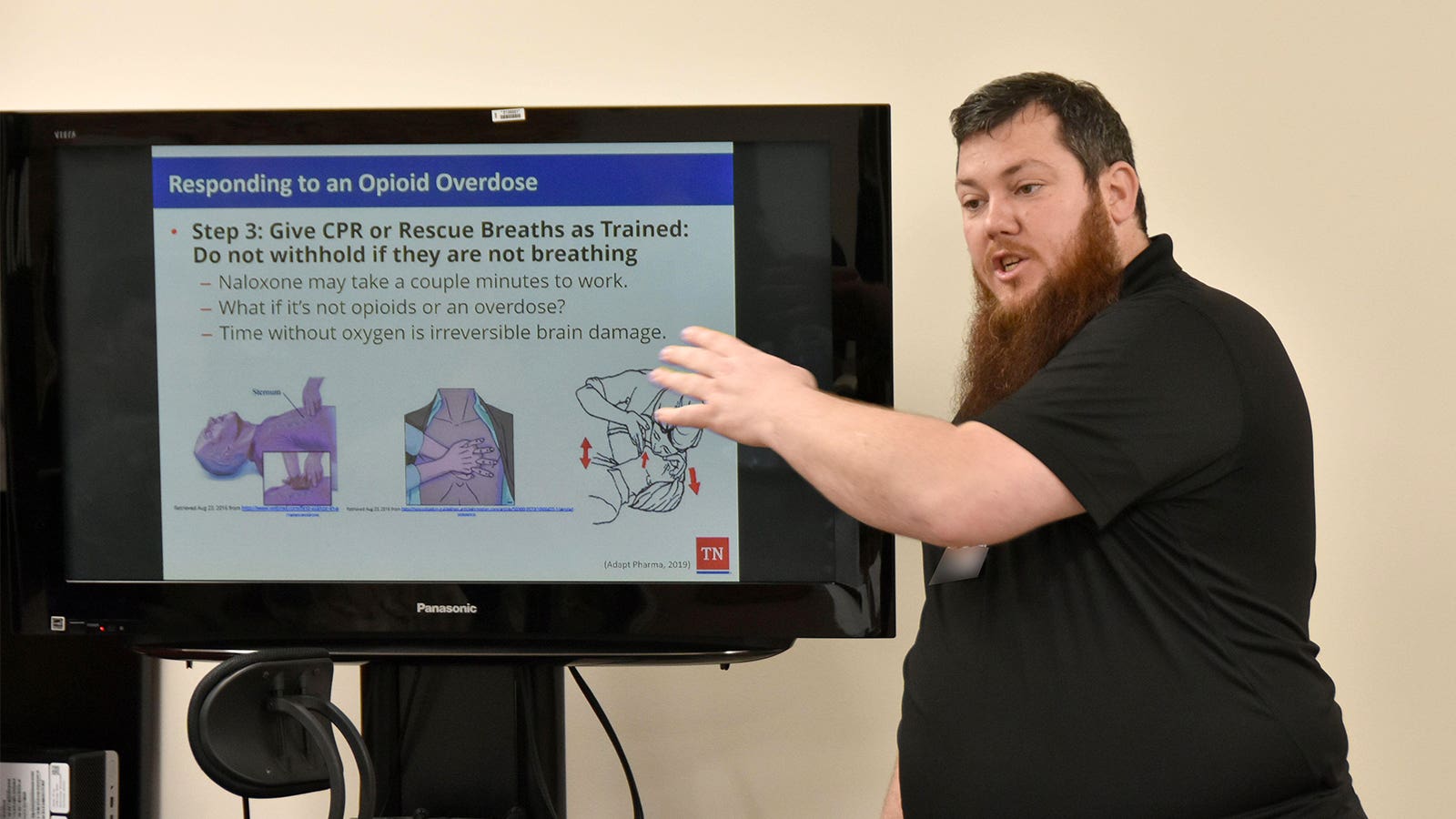 A photo of a man leading a course on responding to an overdose.